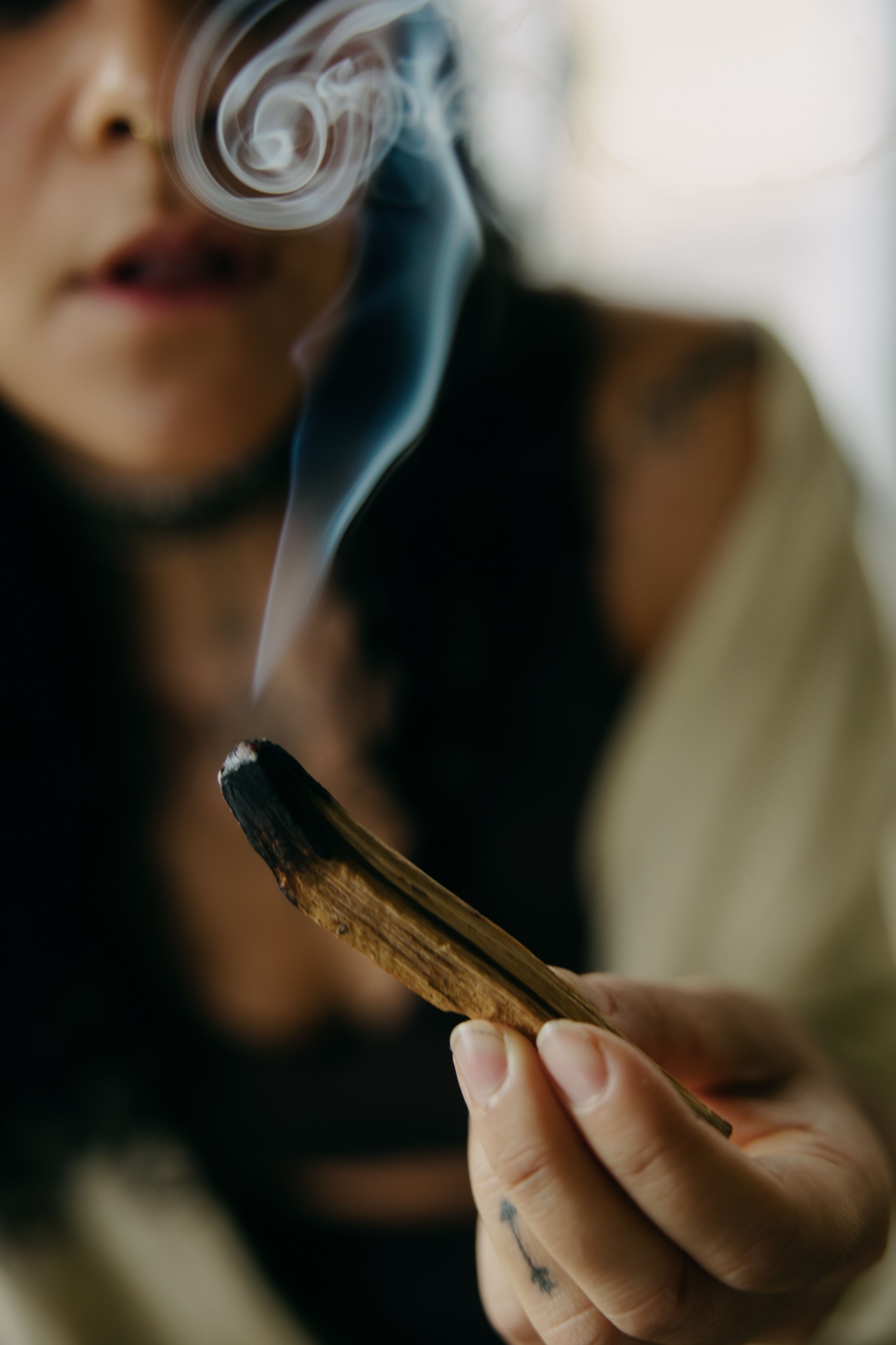 Palo santo smoke curling in soft light